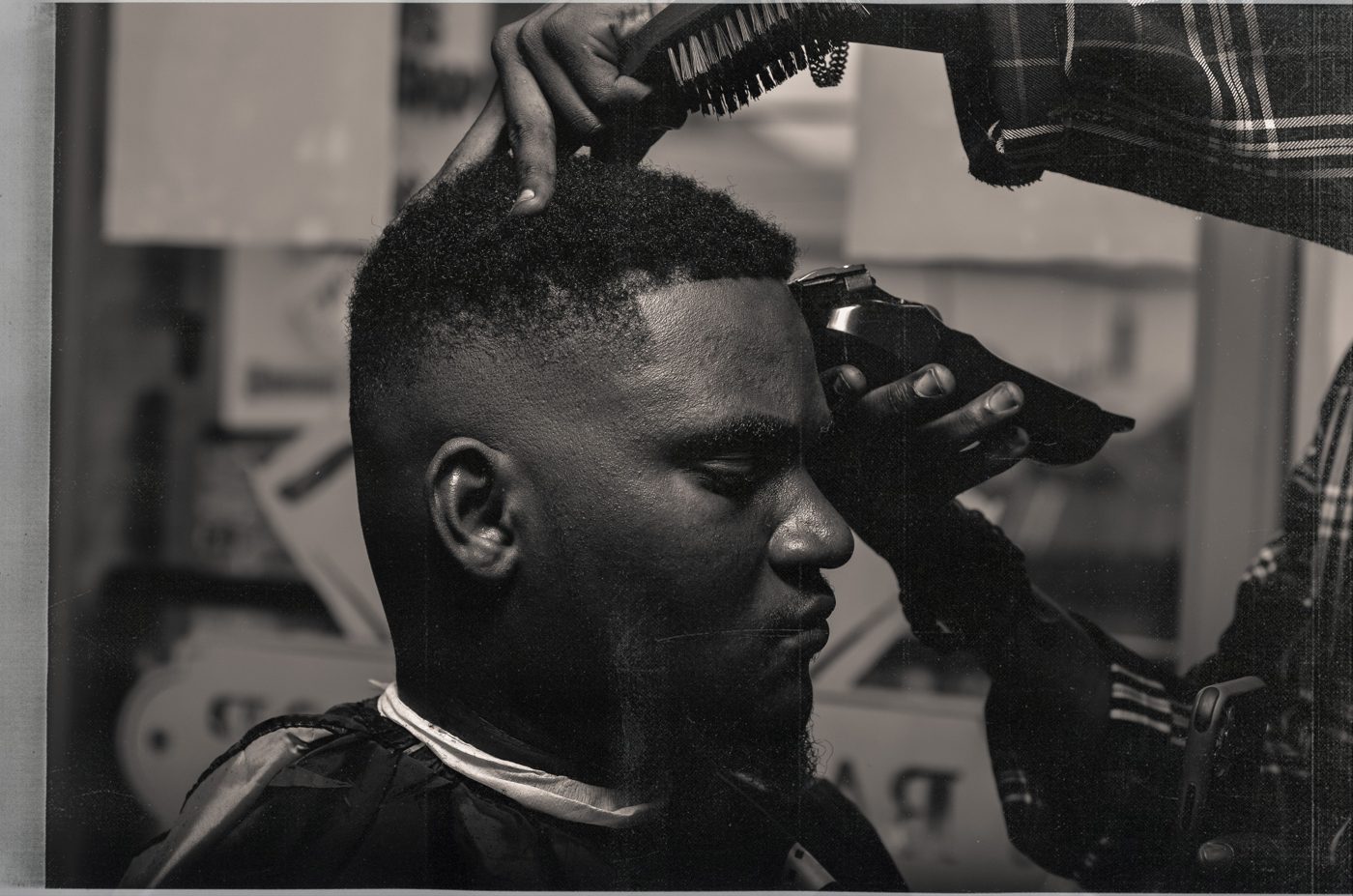 A skilled barber delivering a clean fade — the best barbers bring their own clients and their own craft.