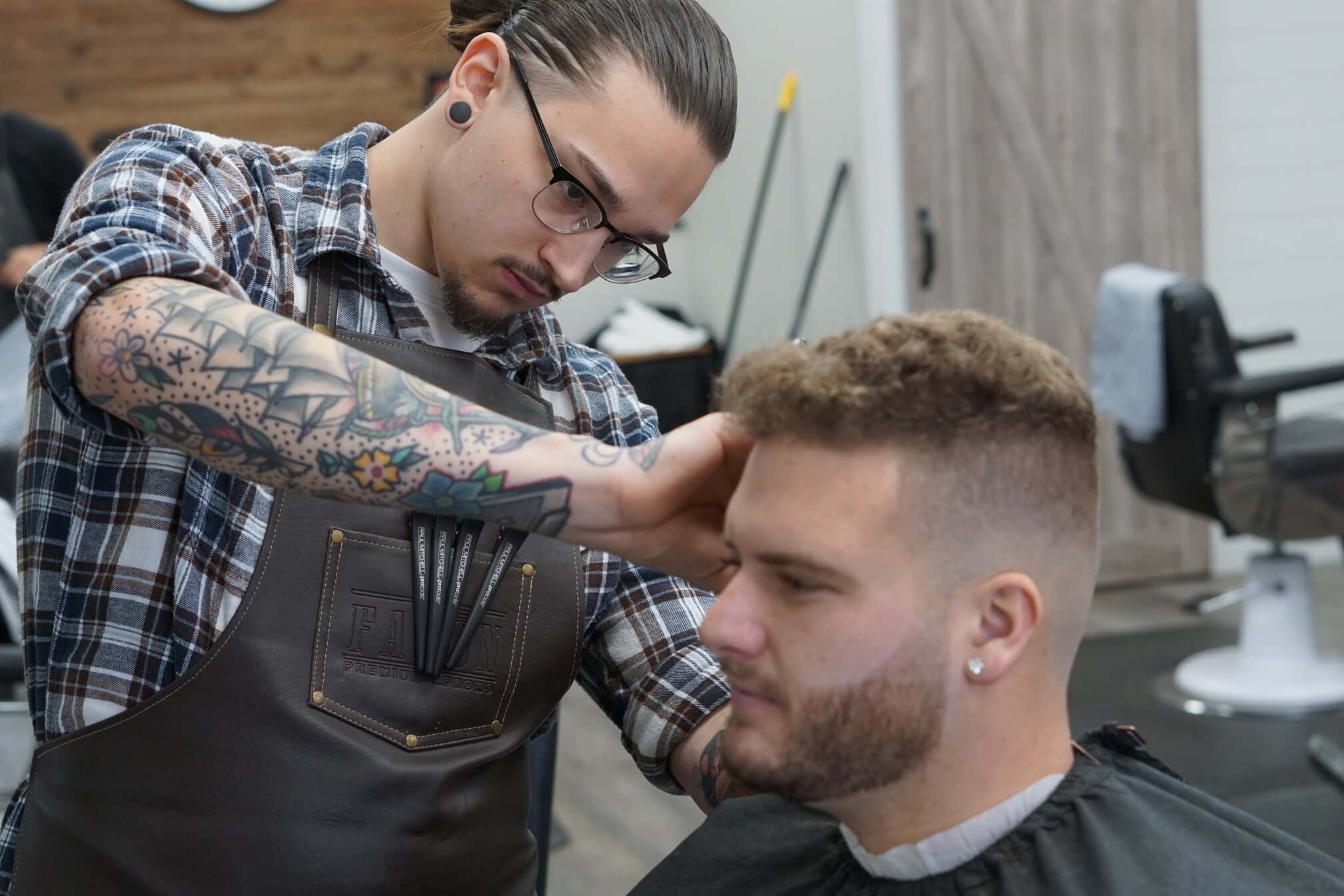 A skilled barber delivering a precision fade — the kind of professional shop owners find through ChairUp.
